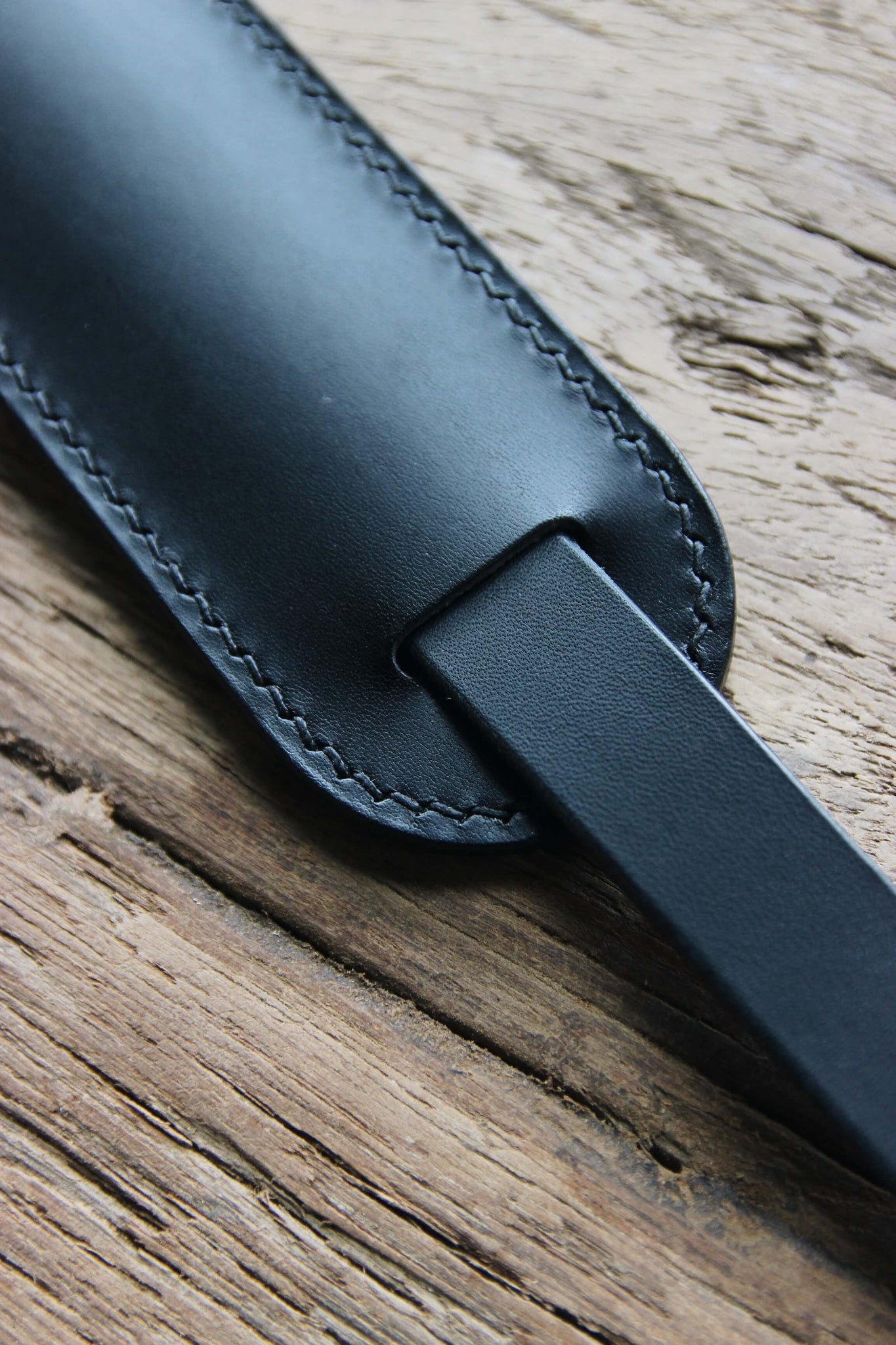 Schulterpad eines Leder Kameragurts in Schwarz in der Nahaufnahme.